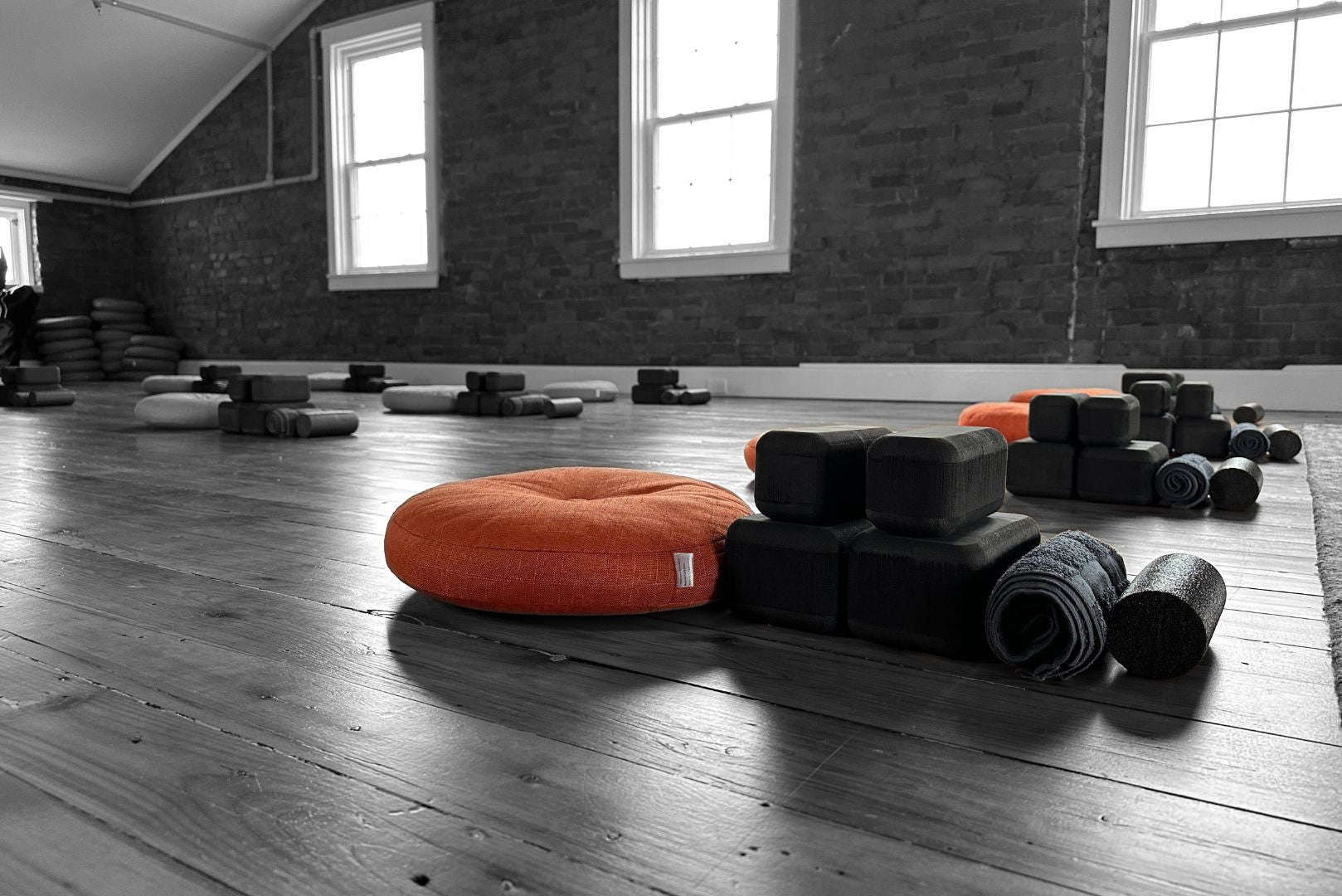 (un)Block fascia release tools with rolled up towel and pool noodle on a wood-floor 