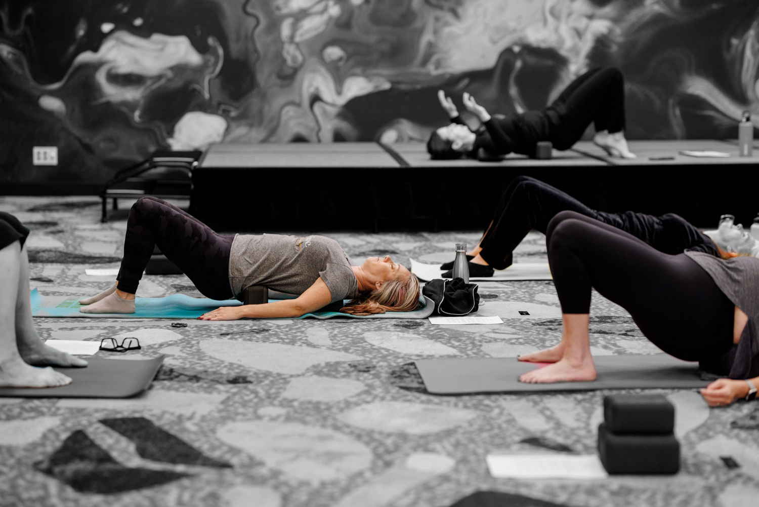 people in an unwind class, lying on four (un)blocks on their back.